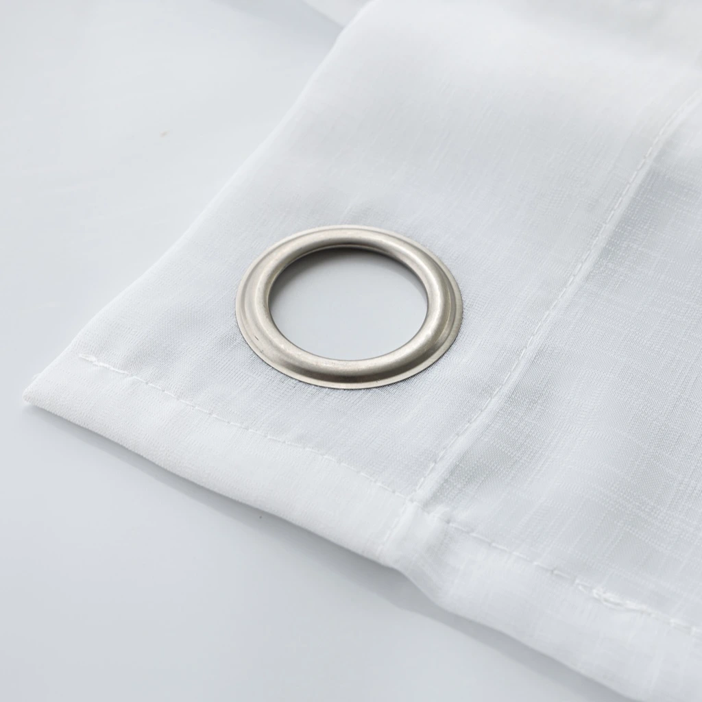Close-up van matte roestvrij stalen ringen in helder witte Bibiana vitrage met zichtbare zoom en katoenmotief